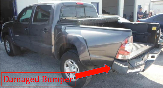 damaged bumper of pickup truck after getting rear ended by a car